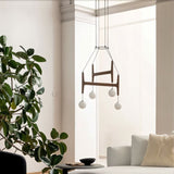 The walnut version in a living room beside a tall plant and a low sofa