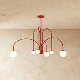 The same arched frame in red, the opal globes lit at the end of each arm