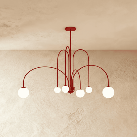 The same arched frame in red, the opal globes lit at the end of each arm