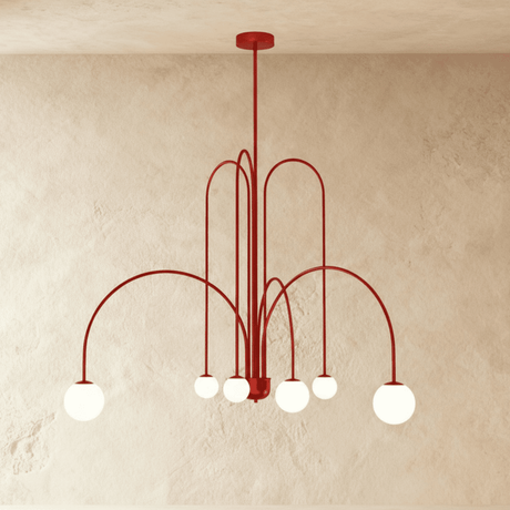 The red frame turned so the arched arms cross above the lit opal globes