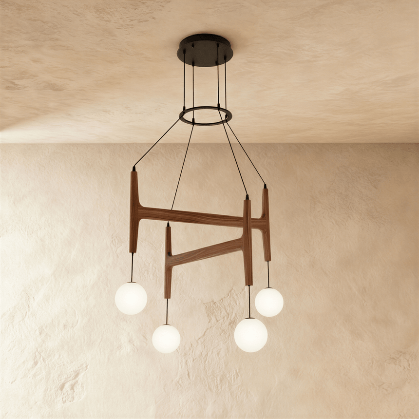 Four milk glass globes hanging from crossed walnut bars on thin cables