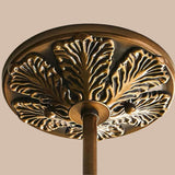 Close view of the cast brass ceiling plate with a leaf pattern around it