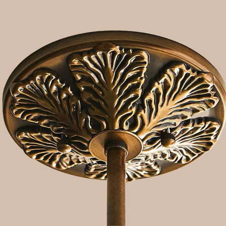Close view of the cast brass ceiling plate with a leaf pattern around it
