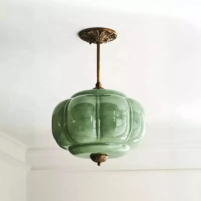 Green ribbed melon shade on a short brass rod under a white ceiling