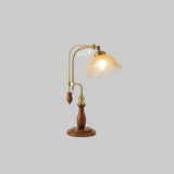 Brass arch lamp with an amber crackle glass shade, lit warm