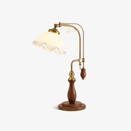 Table lamp with a brass double arch carrying a ruffled milky glass bell