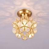 Clear glass petal ceiling light lit against a pale ceiling