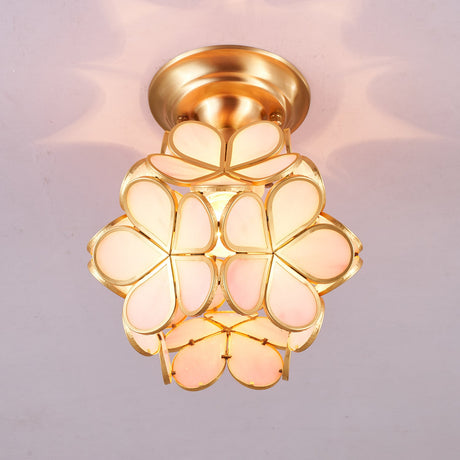 Pink glass petal ceiling light lit against a pale ceiling