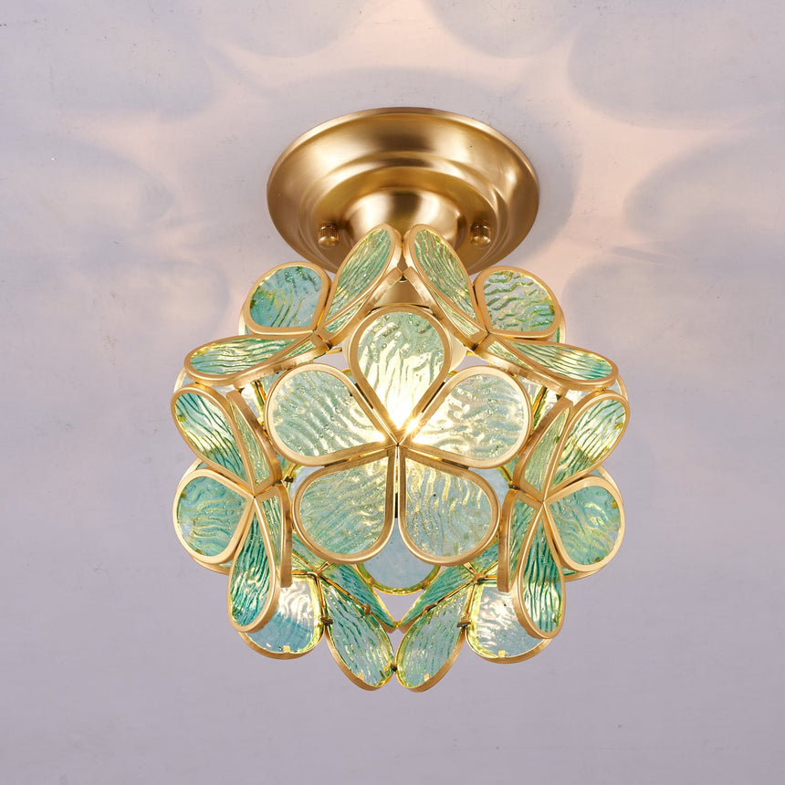 Green glass petal ceiling light seen at an angle