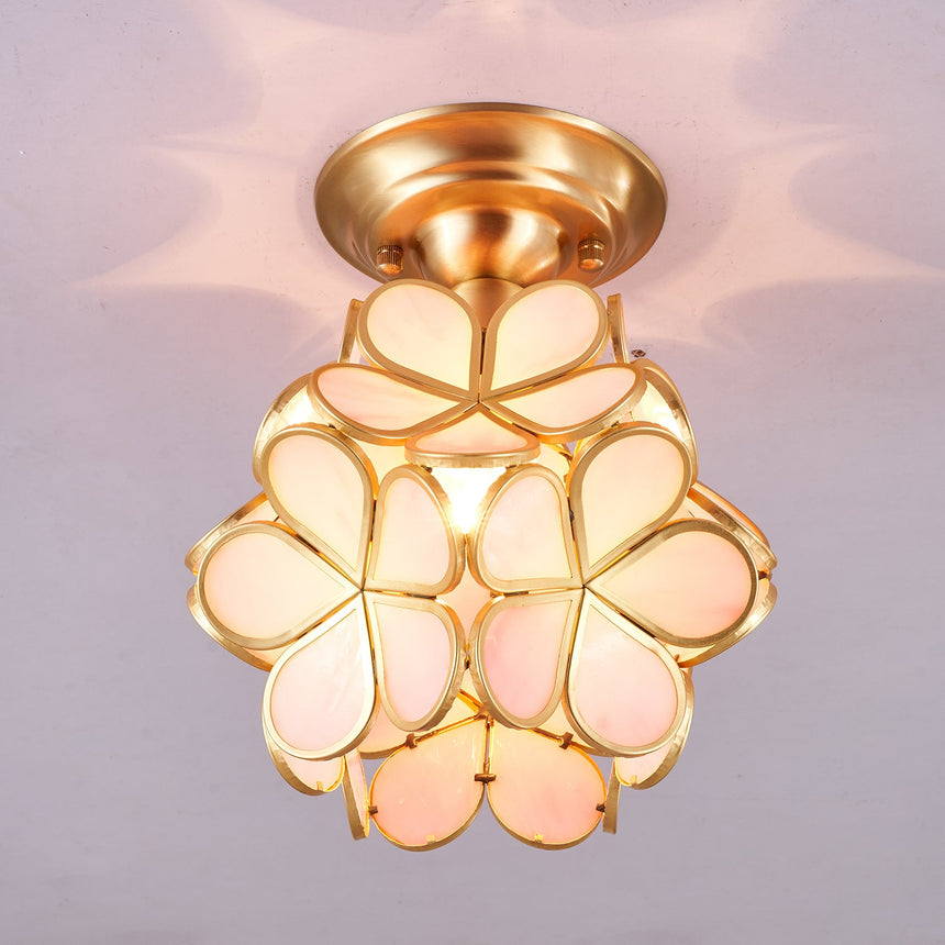 Pink glass petal ceiling light seen at an angle, lit