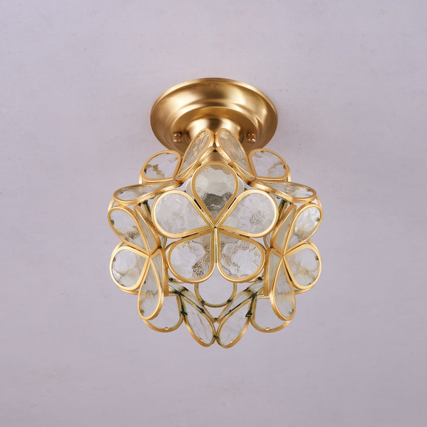 Clear glass petal ceiling light unlit against a plain ceiling