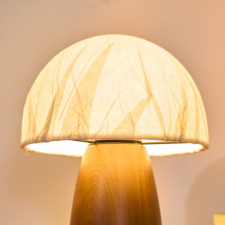 Close view of the lit edge of the paper dome above the wood cone