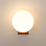 The sphere lit bright, warm light spilling onto the wall around it
