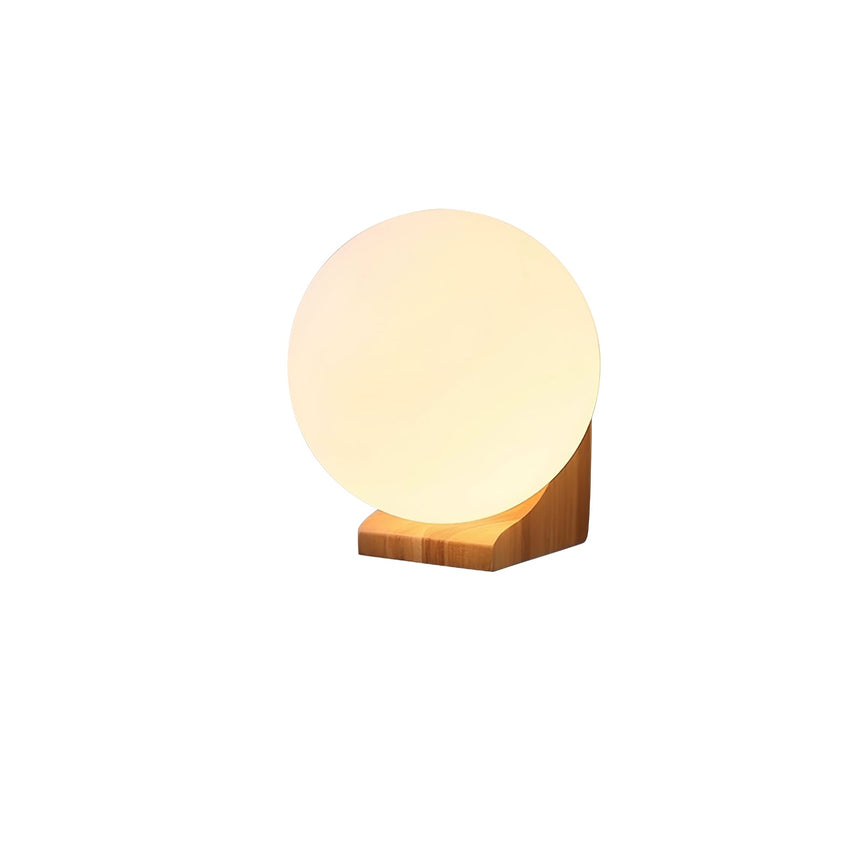The pale wood bracket lit, the sphere glowing warm above the wood