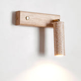 The wood arm extended from the wall with the stone tube angled at its end