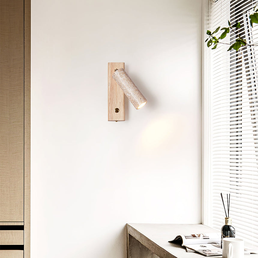 Sconce lit beside a blind above a console with a diffuser and a notebook