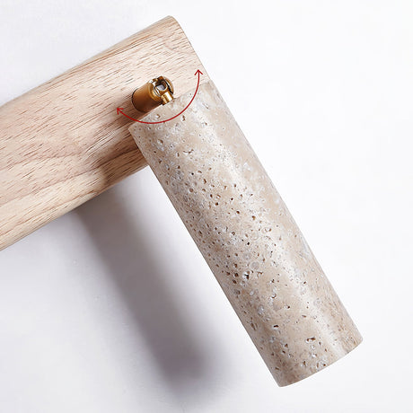 The porous travertine tube joined to the wood arm by a small brass collar