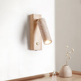 The stone tube tilted down on its wood plate, the beam falling on the wall