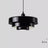 Layered metal shade in black on a plain background
