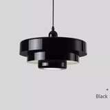 Layered metal shade in black on a plain background