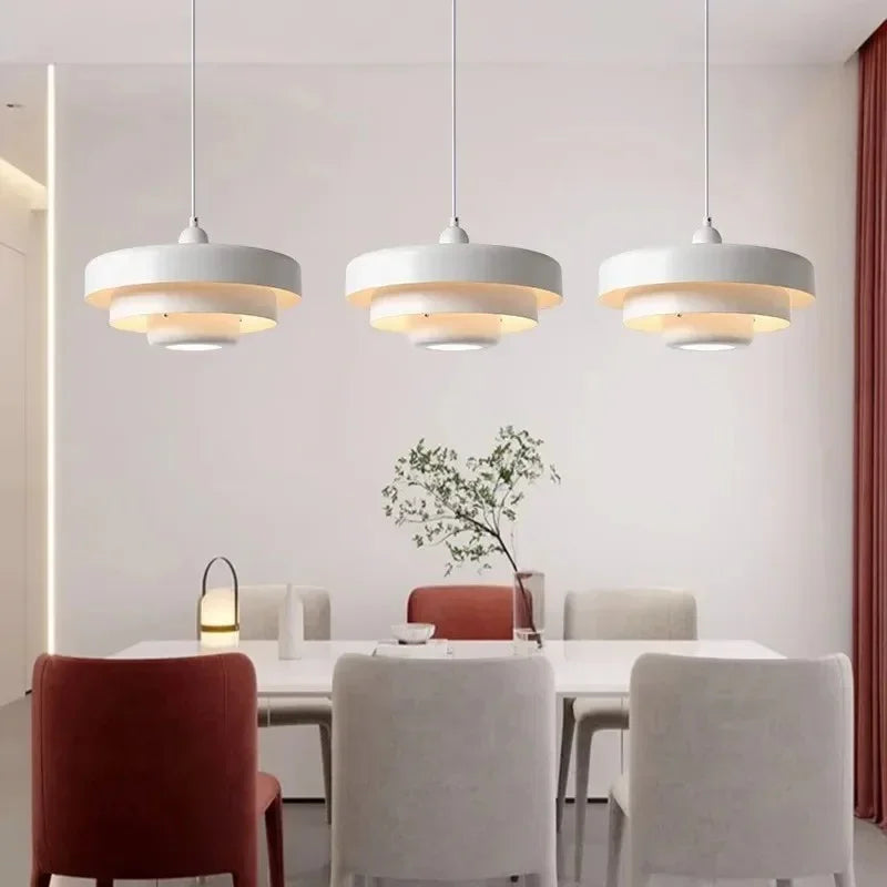 Pale layered shades hung above a dining table