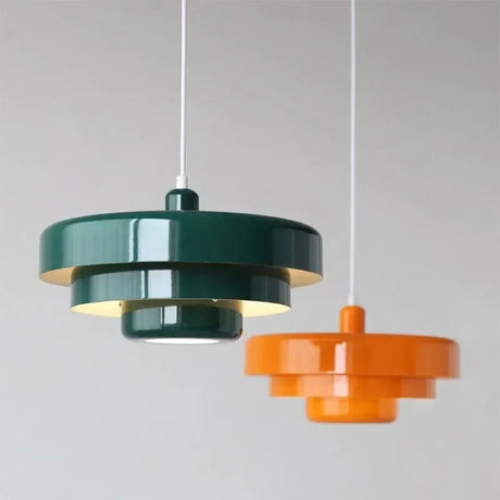 Two green layered shades hung at different heights