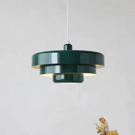 Layered metal shade in green on a plain background