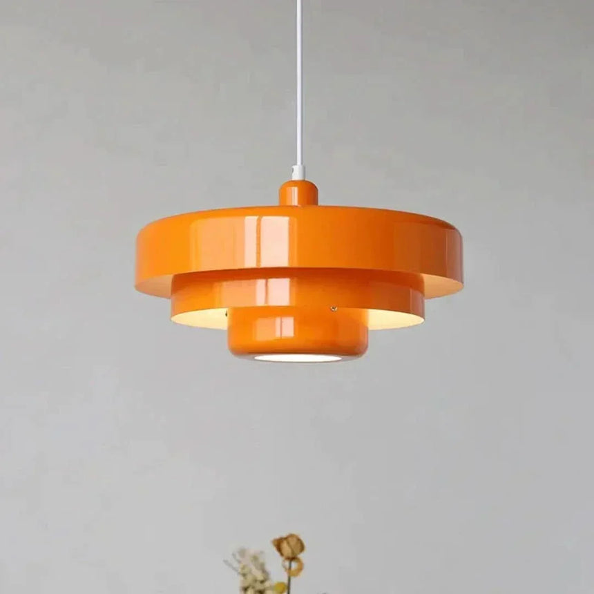 Layered metal shade in orange on a plain background