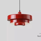 Layered metal shade in red on a plain background