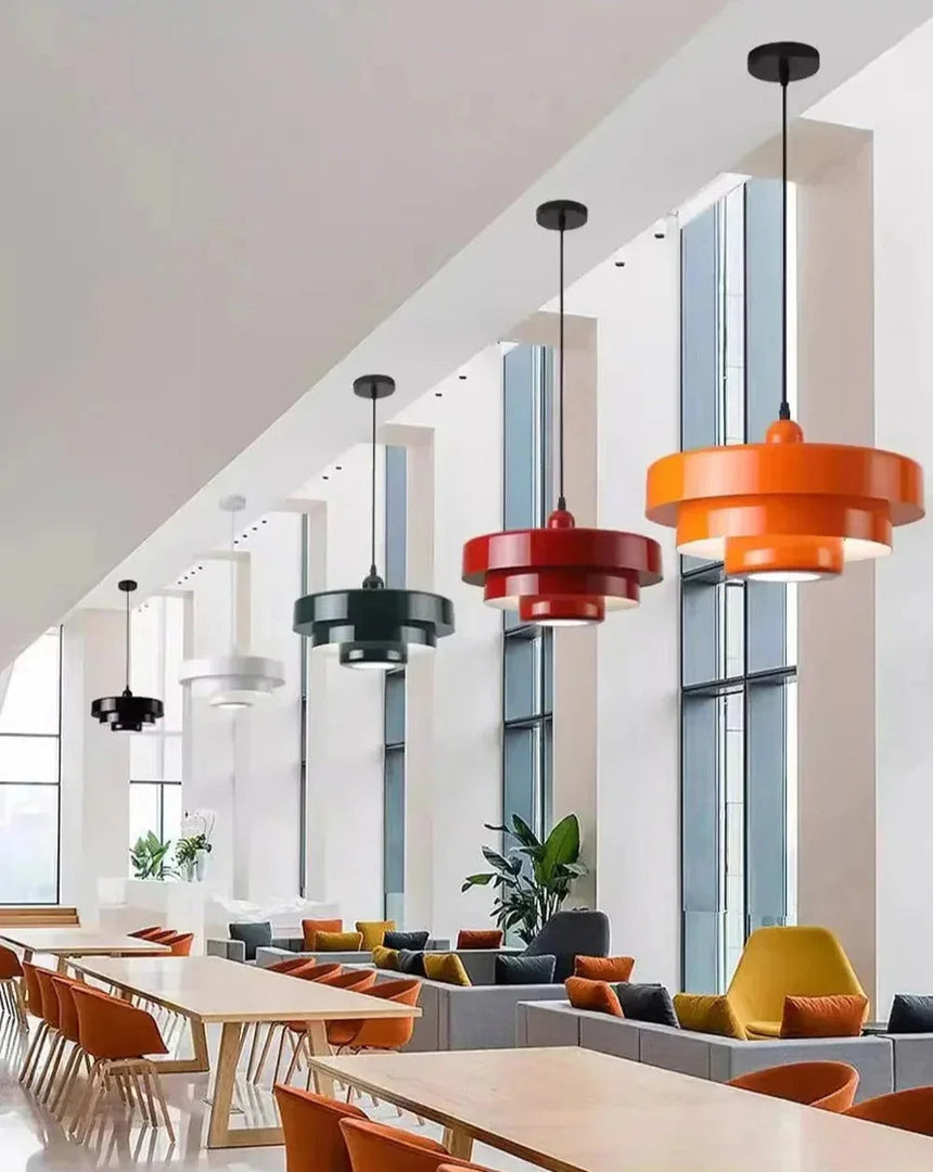 Row of orange and green layered shades above a long table