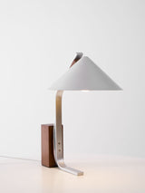 Minimalist desk lamp with a white cone shade seen from the front