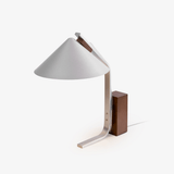Minimalist desk lamp with an aluminum arc and a walnut block, plain ground