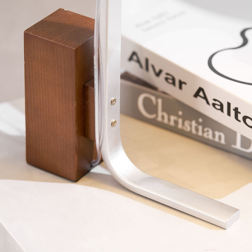 Close view of the walnut block and the brushed aluminum arc