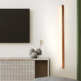 The bar mounted vertically beside a sideboard, lighting the wall