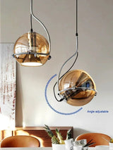 Two mirrored globes turned at different angles above a dining setting