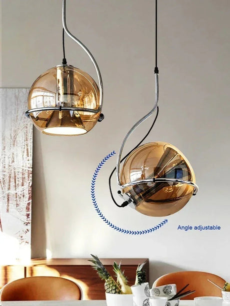 Two mirrored globes turned at different angles above a dining setting