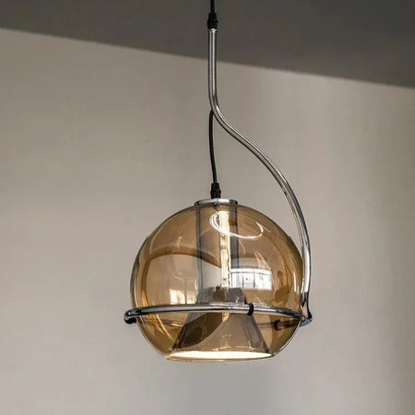 The globe lit from inside beside a tall window in a pale room