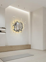 The mirrored light lit in a bright hallway above a wood bench
