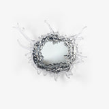 Round mirror wall light framed by a sculpted splash of clear drops in a chrome finish