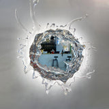The mirror reflecting a room, framed by clear sculpted drops