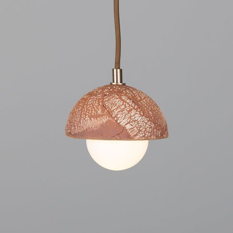 Ceramic pendant light above kitchen island