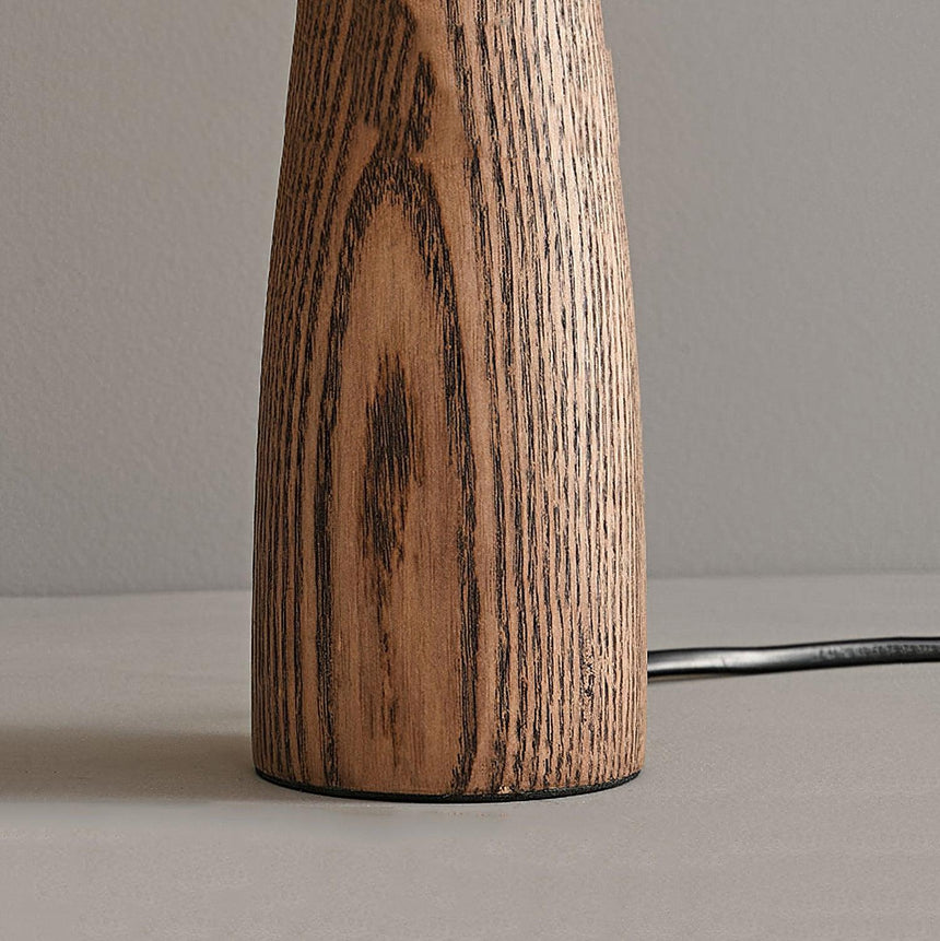 Close view of the open grain of the tapered wood base