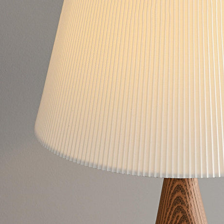 Close view of the fine ribbed pleats of the shade above the wood base