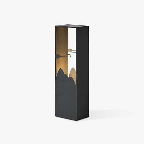 Dark bollard with a mountain profile cut into a lit brass inner face