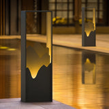Two lit beside still water reflecting the warm inner face of each body
