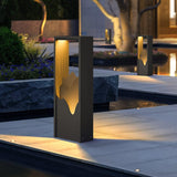 Two lit on paving beside a water feature with planting behind them