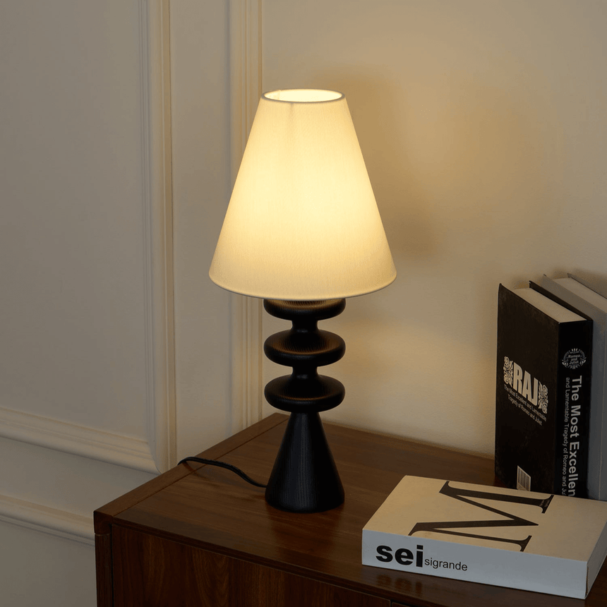 Close view of the lit shade above the rippled turned wood base
