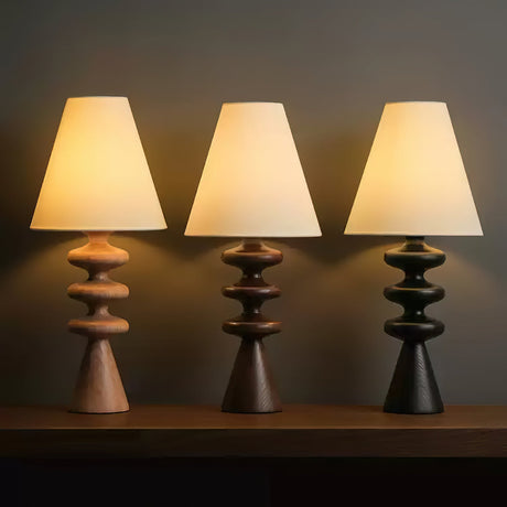 Three rippled base lamps side by side in light wood, walnut and black