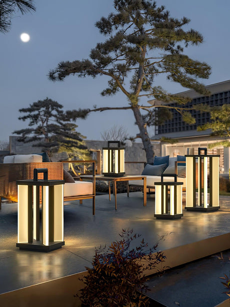 Lanterns lit on a terrace under a pine with a moon in the sky behind