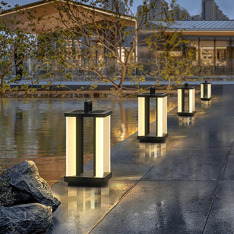 A row of lanterns lit beside still water reflecting the light at dusk